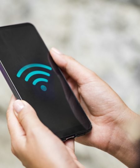 close-up-phone-hands-with-wifi-symbol.jpg
